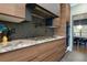 Modern kitchen with stainless appliances, designer backsplash, and stylish wood cabinetry at 225 Nacoochee Dr, Woodstock, GA 30188