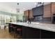Kitchen with granite island with seating, modern appliances, and unique light fixtures at 225 Nacoochee Dr, Woodstock, GA 30188
