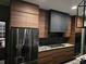 Modern kitchen featuring flat-panel wood cabinets, granite countertops, and a stainless steel refrigerator at 225 Nacoochee Dr, Woodstock, GA 30188