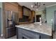 Modern kitchen featuring stainless steel appliances, a granite island, and stylish wood cabinetry at 225 Nacoochee Dr, Woodstock, GA 30188