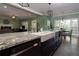 Modern kitchen boasts granite countertops, stainless steel appliances, island with seating and open floorplan at 225 Nacoochee Dr, Woodstock, GA 30188