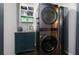 Functional laundry room with stacked washer and dryer and sink at 225 Nacoochee Dr, Woodstock, GA 30188