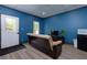 Living room features laminate flooring, a brown couch, a TV, and a mini-fridge at 225 Nacoochee Dr, Woodstock, GA 30188