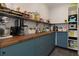 Well-stocked pantry with wooden countertops, blue cabinets, and metal shelving for optimal kitchen storage at 225 Nacoochee Dr, Woodstock, GA 30188