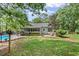 Large yard with a kidney shaped pool, fenced yard, mature trees, and exterior of house at 24 Picketts Mill Pl, Acworth, GA 30101
