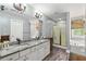 Bathroom with double vanity, granite countertop, tub, shower, and gray walls at 24 Picketts Mill Pl, Acworth, GA 30101
