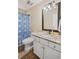 Well-lit bathroom features granite countertops, white cabinets, and a shower with a blue decorative curtain at 24 Picketts Mill Pl, Acworth, GA 30101