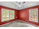 Bedroom with carpet flooring, two windows and red walls at 24 Picketts Mill Pl, Acworth, GA 30101