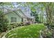 Well-maintained home with green siding, manicured lawn, and stone walkway at 24 Picketts Mill Pl, Acworth, GA 30101