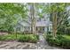 Charming single-story home featuring lush landscaping, a stone pathway, and a welcoming front porch at 24 Picketts Mill Pl, Acworth, GA 30101