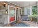 Inviting front porch featuring stone accents, a hanging swing, and a cheerful welcome sign at 24 Picketts Mill Pl, Acworth, GA 30101