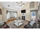 Cozy living room with a fireplace, TV, and a comfortable seating area under a high, vaulted ceiling at 24 Picketts Mill Pl, Acworth, GA 30101