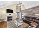 Open-concept living room with fireplace, wood flooring, and comfortable seating at 24 Picketts Mill Pl, Acworth, GA 30101
