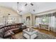 Bright living room with high ceilings, ceiling fans, and large windows for ample natural light at 24 Picketts Mill Pl, Acworth, GA 30101
