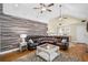 Inviting living room features vaulted ceilings, a wood accent wall, and a large leather sectional sofa at 24 Picketts Mill Pl, Acworth, GA 30101