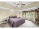 Serene primary bedroom with a bay window, tray ceiling, and comfortable bedding at 24 Picketts Mill Pl, Acworth, GA 30101
