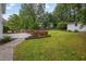 Spacious backyard features green grass, a concrete patio, and a small shed with mature landscaping and flowers at 3182 Wakefield Dr, Decatur, GA 30034