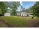 Well-maintained backyard featuring ample green space, a concrete patio, and a storage shed on the property at 3182 Wakefield Dr, Decatur, GA 30034