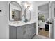 Bathroom boasts double vanity with marble counters, grey cabinets, arched mirrors, and open access to Primary bedroom at 3182 Wakefield Dr, Decatur, GA 30034