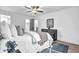 Comfortable bedroom with a plush bed, dark grey dresser, ceiling fan, and neutral decor at 3182 Wakefield Dr, Decatur, GA 30034