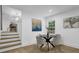 Dining area with a round table, modern art, and a staircase leading to another level at 3182 Wakefield Dr, Decatur, GA 30034