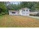 Attractive white home featuring a two-car garage, complemented by a well-kept front lawn at 3182 Wakefield Dr, Decatur, GA 30034