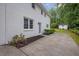 Two-story home featuring a white brick exterior, updated windows, and a side entry door to the home's concrete patio at 3182 Wakefield Dr, Decatur, GA 30034