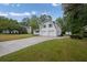 Wide view of home with two-car garage and long driveway bordered by a green lawn at 3182 Wakefield Dr, Decatur, GA 30034