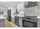 This kitchen features a stainless steel range, gray cabinets, and a farmhouse sink with modern fixtures at 3182 Wakefield Dr, Decatur, GA 30034