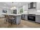 This kitchen features an island with seating, stainless steel appliances, and white upper with gray lower cabinets at 3182 Wakefield Dr, Decatur, GA 30034