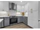 This kitchen boasts white upper and gray lower cabinets, stainless steel appliances, and subway tile backsplash at 3182 Wakefield Dr, Decatur, GA 30034