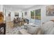 Open-concept living room with a dining area, comfortable seating, and access to the backyard at 3182 Wakefield Dr, Decatur, GA 30034