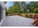 Large concrete patio with flower beds adds charm to the backyard and provides ample space for outdoor enjoyment at 3182 Wakefield Dr, Decatur, GA 30034