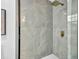 Stylish walk-in shower features marble-style tiling, glass enclosure, and modern fixtures at 3182 Wakefield Dr, Decatur, GA 30034