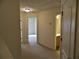 Neutral hallway featuring carpeting and doors leading to other rooms, creating a seamless flow at 615 Magnolia Gardens Walk, Mcdonough, GA 30253