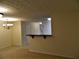 Open living space leading into hallway and a raised bar at 615 Magnolia Gardens Walk, Mcdonough, GA 30253