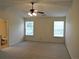 Spacious main bedroom with two windows and a ceiling fan at 615 Magnolia Gardens Walk, Mcdonough, GA 30253
