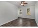 Charming bedroom with wood-look flooring, ceiling fan and natural light from two windows at 651 Deer Oaks Dr, Lawrenceville, GA 30044