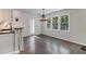 Bright breakfast nook area with modern lighting, large windows, and hardwood floors at 651 Deer Oaks Dr, Lawrenceville, GA 30044