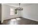 Dining room featuring hardwood floors, modern chandelier, and natural light from a large window at 651 Deer Oaks Dr, Lawrenceville, GA 30044