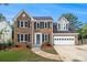 Charming two-story brick home boasts a manicured lawn, attached two car garage, and inviting curb appeal at 651 Deer Oaks Dr, Lawrenceville, GA 30044