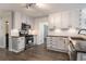 Updated kitchen features stainless appliances, granite counters, white cabinets, and stylish tile backsplash at 651 Deer Oaks Dr, Lawrenceville, GA 30044