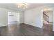Open-concept living room with hardwood floors, modern light fixture, and a view into adjacent rooms at 651 Deer Oaks Dr, Lawrenceville, GA 30044