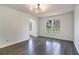 Open-concept living room featuring hardwood floors, modern light fixture and large windows for natural light at 651 Deer Oaks Dr, Lawrenceville, GA 30044
