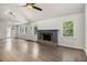 Spacious living room with hardwood floors, stone fireplace, large windows offering views of the surrounding landscape at 651 Deer Oaks Dr, Lawrenceville, GA 30044