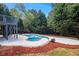 Backyard features a private in-ground pool and surrounding greenery at 651 Deer Oaks Dr, Lawrenceville, GA 30044