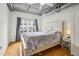 Bright bedroom with hardwood floors, ceiling fan, and large window with views at 800 Peachtree Ne St # 2304, Atlanta, GA 30308