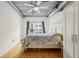 Bright bedroom with hardwood floors, ceiling fan, and large window at 800 Peachtree Ne St # 2304, Atlanta, GA 30308