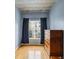 Bright bedroom featuring hardwood floors and a view of the cityscape at 800 Peachtree Ne St # 2304, Atlanta, GA 30308