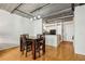 Open-concept dining area with hardwood floors, modern lighting, and a view into the kitchen at 800 Peachtree Ne St # 2304, Atlanta, GA 30308